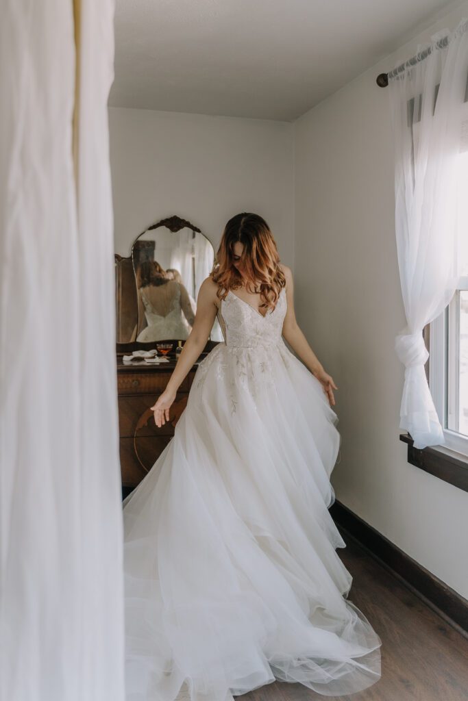 A beautiful bride getting ready, wearing a princess style wedding dress.